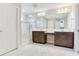 Elegant bathroom featuring a double vanity, a glass-enclosed shower, and luxurious marble flooring for a spa-like experience at 17802 Everlong Dr, Land O Lakes, FL 34638