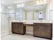 Elegant bathroom featuring a double vanity, a glass-enclosed shower, and luxurious marble flooring for a spa-like experience at 17802 Everlong Dr, Land O Lakes, FL 34638