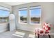 Bright bedroom showcases scenic pond views from the windows, and accent chair, perfect for relaxation and contemplation at 17802 Everlong Dr, Land O Lakes, FL 34638