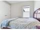 Well-lit bedroom features a comfortable bed, plush carpeting, and a bright window, creating a cozy atmosphere at 17802 Everlong Dr, Land O Lakes, FL 34638