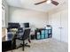 Functional bedroom with a ceiling fan, desk, and ample storage space, perfect for a home office at 17802 Everlong Dr, Land O Lakes, FL 34638