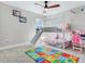 Colorful bedroom with carpet, bunk bed with slide, desk, and fun decor, offering a playful space at 17802 Everlong Dr, Land O Lakes, FL 34638