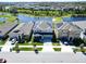 A lovely two-story home with solar panels, complemented by a lush lawn and peaceful lake backdrop at 17802 Everlong Dr, Land O Lakes, FL 34638