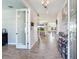 Bright foyer with wood-look tile flooring and an open view to the living area at 17802 Everlong Dr, Land O Lakes, FL 34638
