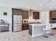 Modern kitchen featuring stainless steel appliances, granite countertops, and bar stool seating at 17802 Everlong Dr, Land O Lakes, FL 34638