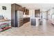 Modern kitchen with stainless steel appliances, a breakfast bar, and an open view into the living area at 17802 Everlong Dr, Land O Lakes, FL 34638