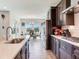 Open concept kitchen with white countertop island, stainless steel appliances, and a view of the dining area at 17802 Everlong Dr, Land O Lakes, FL 34638
