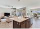 Island in kitchen looks out towards the living room and dining area in this bright open concept house at 17802 Everlong Dr, Land O Lakes, FL 34638