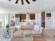 Open-concept living space with views of the kitchen, showcasing modern design and comfortable seating at 17802 Everlong Dr, Land O Lakes, FL 34638