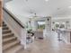 Open-concept living room with wood-look tile floors, bright lighting, and views to the backyard at 17802 Everlong Dr, Land O Lakes, FL 34638