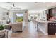 Open-concept living area featuring tile floors, a modern ceiling fan, and sliding glass doors to the backyard at 17802 Everlong Dr, Land O Lakes, FL 34638