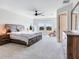 Expansive primary bedroom boasting natural light, a ceiling fan, and a cozy atmosphere for relaxation at 17802 Everlong Dr, Land O Lakes, FL 34638