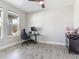 Bright home office with neutral walls, wood-look tile, and a ceiling fan at 17802 Everlong Dr, Land O Lakes, FL 34638