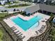 Stunning aerial view of the community pool with ample seating, landscaping, and an open-air social area at 17802 Everlong Dr, Land O Lakes, FL 34638