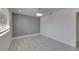 Bright bedroom features gray accent wall and wood laminate flooring at 1828 Bough Ave # 3, Clearwater, FL 33760