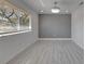 Spacious bedroom with large window and wood laminate flooring at 1828 Bough Ave # 3, Clearwater, FL 33760