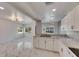 Well-lit kitchen featuring white cabinets, granite countertops, stainless steel appliances, and marble flooring at 1828 Bough Ave # 3, Clearwater, FL 33760