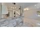 Kitchen bar with marble and pendant lights, next to the living area with marble floors at 1828 Bough Ave # 3, Clearwater, FL 33760