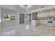 Bright and spacious kitchen featuring white cabinets, granite countertops, and modern appliances at 1828 Bough Ave # 3, Clearwater, FL 33760