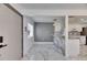 Bright open living room and kitchen with modern finishes and marble tile flooring throughout at 1828 Bough Ave # 3, Clearwater, FL 33760