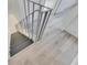 Staircase with dark gray steps and light gray wood floors and metal railing at 1828 Bough Ave # 3, Clearwater, FL 33760