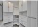 Well-organized walk-in closet with white cabinets, drawers, and shelving offering ample storage at 1828 Bough Ave # 3, Clearwater, FL 33760