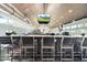 Modern bar with liquor display and bar stool seating at 19469 Autumn Oak Ln, Brooksville, FL 34601