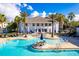 Luxurious pool area with ample seating and shade, surrounded by lush tropical landscaping at 19469 Autumn Oak Ln, Brooksville, FL 34601