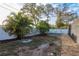 Landscaped backyard with privacy fence, decorative rock, and foliage at 2005 Harvard Ave, Dunedin, FL 34698