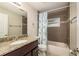 Bathroom featuring a granite vanity and bathtub with tiled shower at 2005 Harvard Ave, Dunedin, FL 34698