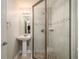 Modern bathroom features a glass-enclosed shower with neutral tile and mosaic accents at 2005 Harvard Ave, Dunedin, FL 34698