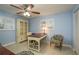 Bedroom features a decorative ceiling fan, shutters, desk, and nice built-ins at 2005 Harvard Ave, Dunedin, FL 34698