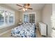 Cozy bedroom featuring a ceiling fan, white shutters, and bright natural light at 2005 Harvard Ave, Dunedin, FL 34698