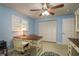 Bedroom features a decorative ceiling fan, shutters, desk, and nice built-ins at 2005 Harvard Ave, Dunedin, FL 34698