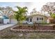 Charming single-story home with a well-manicured front yard and mature palm trees at 2005 Harvard Ave, Dunedin, FL 34698