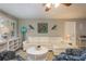 Bright living room showcasing a white couch, cheerful decor and abundant natural light at 2005 Harvard Ave, Dunedin, FL 34698