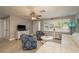 Inviting living space with ceiling fan, tiled floors and abundant natural light at 2005 Harvard Ave, Dunedin, FL 34698