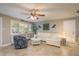 Cozy living room featuring plantation shutters, ceiling fan and comfortable seating at 2005 Harvard Ave, Dunedin, FL 34698