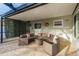 Relaxing outdoor patio with comfortable seating, privacy screen, and decorative elements at 2005 Harvard Ave, Dunedin, FL 34698