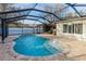 Enclosed pool area with brick patio, small fountain, and steps leading into the inviting water at 2005 Harvard Ave, Dunedin, FL 34698