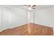 Charming bedroom features wood-look floors, modern ceiling fan, and closet at 207 W Patterson St, Tampa, FL 33604