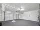 Spacious garage with white walls, gray epoxy floor, and modern automatic garage door at 2217 Stacy Ct, Dunedin, FL 34698