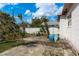 Backyard with concrete patio, outdoor seating, and some tropical landscaping at 2501 Auburn S St, St Petersburg, FL 33712