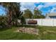 Backyard with a barbecue smoker surrounded by greenery, perfect for outdoor gatherings at 2501 Auburn S St, St Petersburg, FL 33712