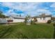 Large backyard with a well-maintained lawn, a BBQ grill, and a secure fence at 2501 Auburn S St, St Petersburg, FL 33712