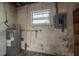 Unfinished basement with hot water tank and electrical panel at 2501 Auburn S St, St Petersburg, FL 33712