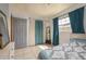 Comfortable bedroom with tiled floors, neutral paint, and natural light streaming in from a window at 2501 Auburn S St, St Petersburg, FL 33712