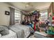 Bedroom with windows and ceiling fan. The closet is overfull of clothes and personal items at 2501 Auburn S St, St Petersburg, FL 33712