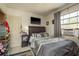 Functional bedroom featuring neutral decor, wall-mounted television, and built-in air conditioning unit at 2501 Auburn S St, St Petersburg, FL 33712