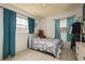 Simple bedroom with a bed, two windows, curtains, and tile floors at 2501 Auburn S St, St Petersburg, FL 33712